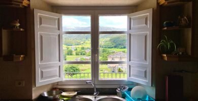 a kitchen with a double sink and open window